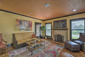 a living room with a couch and a fireplace at Eclectic Houston Home Less Than 4 Mi to Downtown! in Houston