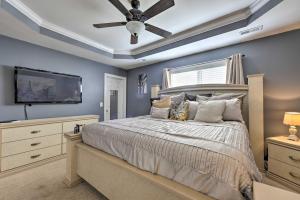 a bedroom with a bed and a ceiling fan at Wendell Home with Fenced Yard, Close to Raleigh in Knightdale