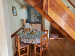 a dining room table with chairs and a kitchen at Super Apart in Miramar