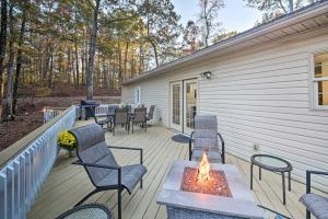 a deck with chairs and a table with a fire pit at Tranquil Family Retreat with Fire Pit and Grill! in Hot Springs Village