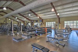a gym with lots of treadmills and machines at Tranquil Family Retreat with Fire Pit and Grill! in Hot Springs Village