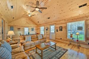 a living room with a couch and a ceiling fan at Breathtaking Elkin Getaway with Vineyard Views! in Elkin