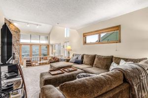 a living room with a couch and a tv at Railbender 8 in Fraser