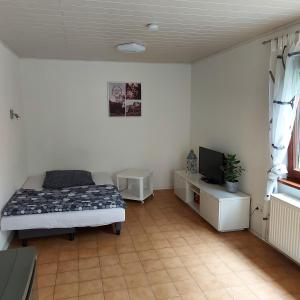 a bedroom with a bed and a tv in it at Feels like Home @ Eppinger in Remseck am Neckar