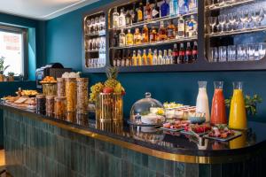 a bar with a buffet of food and drinks at Hôtel Toujours & Spa in Paris