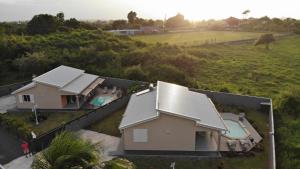 an aerial view of a house with a yard at Les Villas de la Cheminée in Le Moule