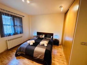 a bedroom with a bed with two towels on it at Apartamento Lozano in Parzán