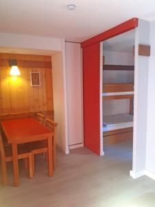 a small room with a table and a bunk bed at Apartment Near The Slopes La Plagne in La Plagne