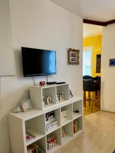 uma sala de estar com televisão numa prateleira branca em Grazer Spatz em Graz