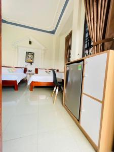 a room with two beds and a chalkboard in it at Eva Homestay in Hue