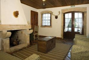 a living room with a fireplace and a couch at Quinta do Brejo - Turismo Equestre in Mafra