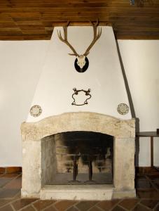 a wooden table with a fire place in front of it at Quinta do Brejo - Turismo Equestre in Mafra