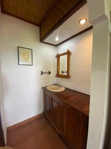 a bathroom with a sink and a mirror at Geriasemalung in Tirtagangga