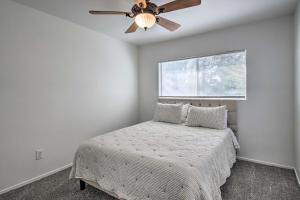 a bedroom with a bed with a ceiling fan at Central Bakersfield Townhome with Private Patio in Bakersfield