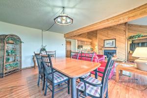 a dining room with a wooden table and chairs at Bellaire Resort Condo Ski, Tube, Explore! in Bellaire