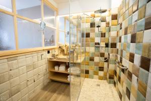 a bathroom with a shower with a glass door at Hotel Don Marcos in Osma