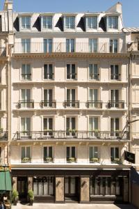 a large white building with windows and balconies at Hotel Whistler - Gare du Nord in Paris