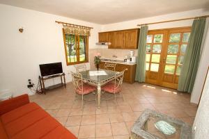 a living room with a table and a kitchen at Holiday Home Linet in Funtana