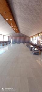a large empty room with a large white tile floor at Bright stars rum camp in Wadi Rum