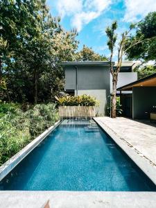 a swimming pool in the backyard of a house at Little Escape in Santa Teresa Beach