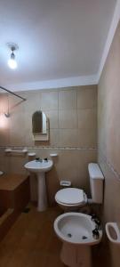 a bathroom with a toilet and a sink at AMANECER in Las Grutas