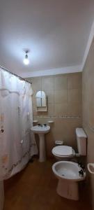 a bathroom with a toilet and a sink at AMANECER in Las Grutas +22 photos