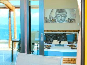 a bedroom with a bed with a statue on the wall at TRA CIELO E LAGO - Gerale H&B (CIR017067-CIM-00420) in Desenzano del Garda