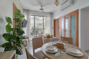 a dining room and living room with a table and chairs at Apartamento N1001 Downtown Santo Domingo in Santo Domingo