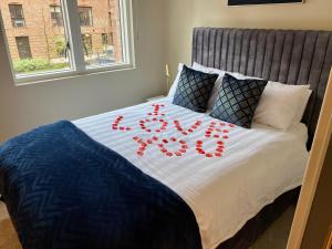 a bed with a bunch of red hearts on it at City Centre Luxury studio apartment suite with garden view in York