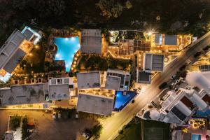 an aerial view of a house with a pool at night at Kouros Exclusive Hotel & Suites - Adults Only in Faliraki