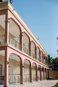 a large building with a balcony on the side at Elektra Hotel in Paleros