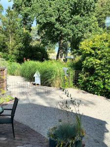 a bench in a garden with a fence and plants at Havsstugan in Sölvesborg