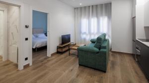 TV a/nebo společenská místnost v ubytování Apartamentos Congreso, Parking gratuito