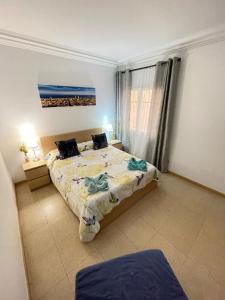 a bedroom with two beds and a painting on the wall at Nuevo Balmes Habitaciones in Barcelona