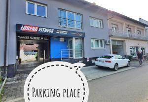 a parking place with a car parked in front of a building at Apartment Anna - FREE pickup from OR dropoff to Zagreb airport, please give three days advance notice - EV station - Long-term parking with airport transport possibility in Velika Gorica