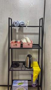 a shelf with baskets of food and a tea kettle at Padang Besar Rainbow Cabin Homestay in Padang Besar