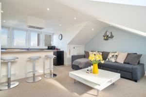 a living room with a couch and a table at Stylish Herne Bay apartment by the sea in Kent