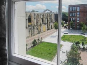 an open window with a view of a building at Priory Place in Gloucester