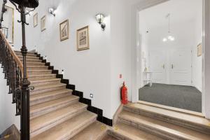 a staircase in a house with a red fire extinguisher at Downtown Bratislava B&B in Bratislava