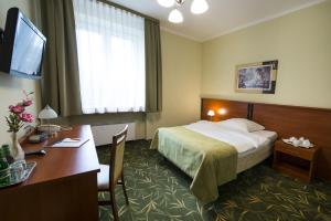 a hotel room with a bed and a desk at Brojan in Jaworzno +23 photos