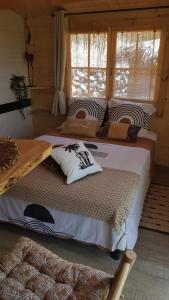 a bedroom with two beds and a window at La lyalis in Aiguines