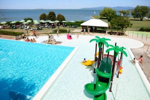 a swimming pool with a water slide in a resort at Camping & Village Polvese in Sant Arcangelo