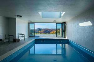 a swimming pool with a view of the mountains at Valley View Breaza in Breaza