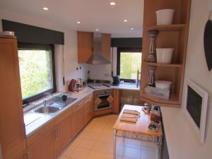 een keuken met een wastafel en een fornuis top oven bij L'Escale Gourmande in Hatrival