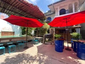 a patio with red umbrellas and tables and chairs at Seconds Colombo in Colombo