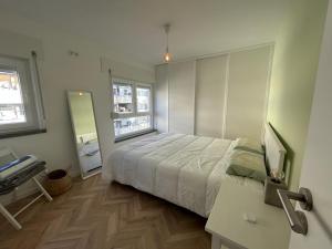 a bedroom with a bed and a desk and a mirror at Simply Yellow Apartment in Lisbon