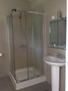 a bathroom with a shower and a sink at Mansea Beach Hotel in Kololi