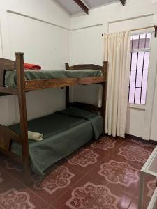 a room with two bunk beds and a window at Pure Canyoning Home in Turrialba