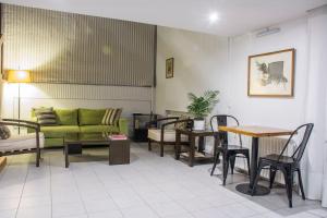 a living room with a couch and a table and chairs at Casa Reconquista in Mendoza