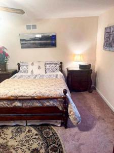 a bedroom with a bed and a table with a lamp at Entire Private 2 bedrooms house, nice neighborhood in Arnold